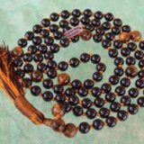 Tourmaline & Tiger Eye Mala Necklace with 108 hand-knotted beads, designed to balance the Root and Solar Plexus Chakras. Offers protection and confidence, ideal for Capricorn and Leo.