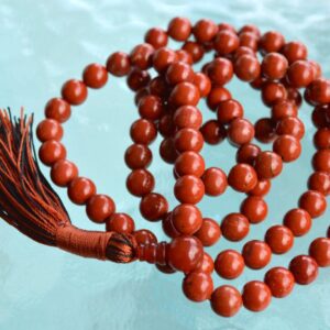 Red Jasper Necklace with 108 hand-knotted beads, designed to activate the Root Chakra. Ideal for Aries and Scorpio, promoting grounding, stability, and courage. Perfect for meditation and spiritual growth.