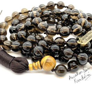 Smokey Quartz Mala Necklace with 108 hand-knotted beads, designed to activate the Root and Solar Plexus Chakras. Offers grounding, stability, and protection. Perfect for Scorpio and Capricorn.