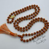 Orange Tulsi Mala Beads Necklace with 108 hand-knotted beads, designed to activate the Heart and Sacral Chakras. Resonates with Leo and Pisces, promoting balance, vitality, and spiritual purity.