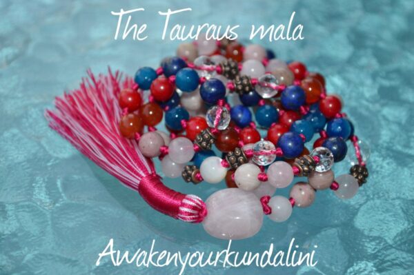 The Ultimate Taurus Mala Necklace made with Carnelian, Rhodonite, Rose Quartz, Red Coral, Jade, Lapis Lazuli, and Crystal Quartz beads. Hand-knotted with copper accents, it supports vitality, protection, and emotional healing. Ideal for Taurus.