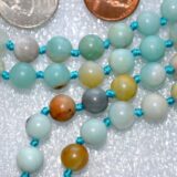 Amazonite Mala Necklace featuring 108 hand-knotted Amazonite beads, promoting communication and emotional balance, with Heart and Throat Chakra alignment, associated with Virgo zodiac and March & September birthstones.