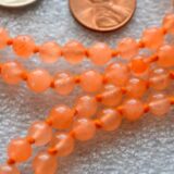 Orange Jade Mala Necklace with 108 hand-knotted beads, designed to activate the Sacral and Solar Plexus Chakras. Ideal for Leo and Sagittarius, boosting creativity and confidence. Perfect for meditation and personal empowerment.