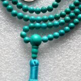 Turquoise Mala Necklace featuring hand-knotted 8mm beads. Ideal for communication and emotional healing, aligns Throat and Heart Chakras. Perfect for Sagittarius and Pisces, and as a December birthstone.