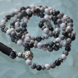 Snowflake Obsidian, White & Black Jade Mala Necklace with 108 hand-knotted beads, designed to balance the Root and Crown Chakras. Resonates with Capricorn and Gemini, offering grounding, protection, and spiritual growth.