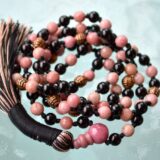 Rhodonite and Black Tourmaline Mala Necklace featuring soft pink and deep black beads, perfect for emotional healing and protection, aligned with Heart and Root Chakras.