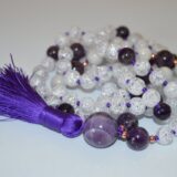 Crackled Quartz & Amethyst Mala Necklace featuring 108 hand-knotted beads, designed to enhance clarity and spiritual protection. Ideal for meditation and spiritual practices, aligning with the Crown and Third Eye Chakras, and resonating with Pisces and Aquarius.