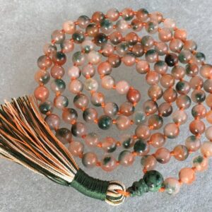 A Flower Jade Mala Beads Necklace with 108 beads plus 1 guru bead. This necklace supports the Heart Chakra, resonates with Libra and Taurus, and promotes emotional healing and harmony. Handcrafted for quality and comfort, ideal for meditation and spiritual practice.