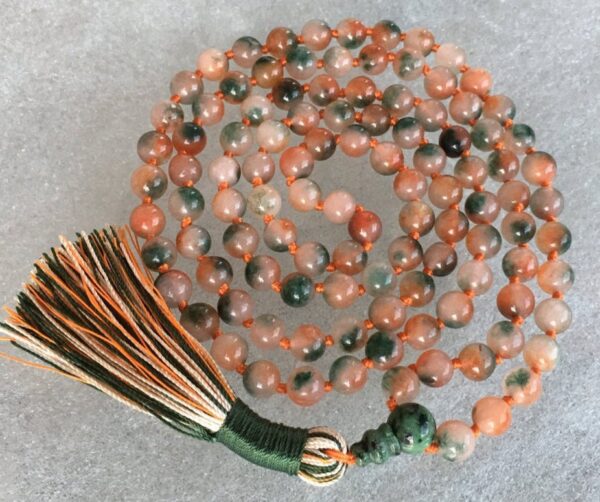 A Flower Jade Mala Beads Necklace with 108 beads plus 1 guru bead. This necklace supports the Heart Chakra, resonates with Libra and Taurus, and promotes emotional healing and harmony. Handcrafted for quality and comfort, ideal for meditation and spiritual practice.