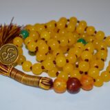 A hand-knotted Yellow Jade Mala Necklace with a focus on prosperity and joy, perfect for Cancer and Taurus zodiac signs, enhancing the Solar Plexus chakra.