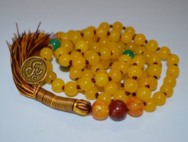 A hand-knotted Yellow Jade Mala Necklace with a focus on prosperity and joy, perfect for Cancer and Taurus zodiac signs, enhancing the Solar Plexus chakra.