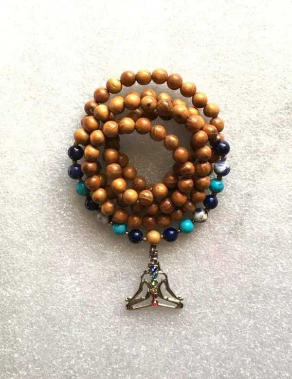 Throat Chakra Balancing Mala Beads Necklace featuring wooden beads, Blue Lace Agate, Aquamarine, and Turquoise, designed for communication enhancement and Throat Chakra support, associated with Aquarius and Pisces zodiac signs.