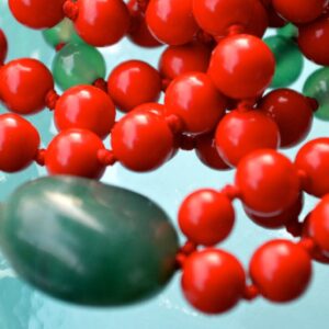 A Red Coral & Jade Mala Necklace featuring 108 beads plus 1 guru bead. This necklace supports the Root and Heart Chakras, resonates with Aries and Taurus, and promotes courage and emotional balance. Handcrafted for quality and comfort, it’s suitable for meditation and spiritual practice.