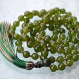 Green Jade Nephrite Mala Necklace featuring 108 hand-knotted Green Jade Nephrite beads, designed for harmony, protection, and emotional healing. Aligns with the Heart Chakra and resonates with Taurus and Libra. Ideal for meditation and daily balance.