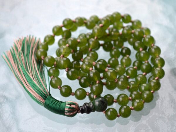 Green Jade Nephrite Mala Necklace featuring 108 hand-knotted Green Jade Nephrite beads, designed for harmony, protection, and emotional healing. Aligns with the Heart Chakra and resonates with Taurus and Libra. Ideal for meditation and daily balance.