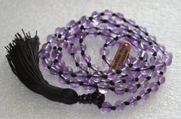 Amethyst Mala Necklace featuring 108 hand-knotted Amethyst beads, designed for spiritual awareness, inner peace, and connection to higher consciousness. Aligns with the Third Eye and Crown Chakras, resonating with Aquarius and Pisces.