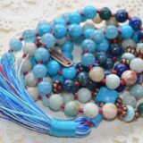 A Mala Beads Necklace featuring Larimar, Turquoise, Aquamarine, Chrysocolla, and Amazonite. This necklace supports the Throat and Third Eye Chakras, promoting clear communication and inner serenity. Handcrafted with 108 beads plus 1 guru bead, it’s ideal for meditation and spiritual practice.