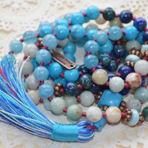 A Mala Beads Necklace featuring Larimar, Turquoise, Aquamarine, Chrysocolla, and Amazonite. This necklace supports the Throat and Third Eye Chakras, promoting clear communication and inner serenity. Handcrafted with 108 beads plus 1 guru bead, it’s ideal for meditation and spiritual practice.