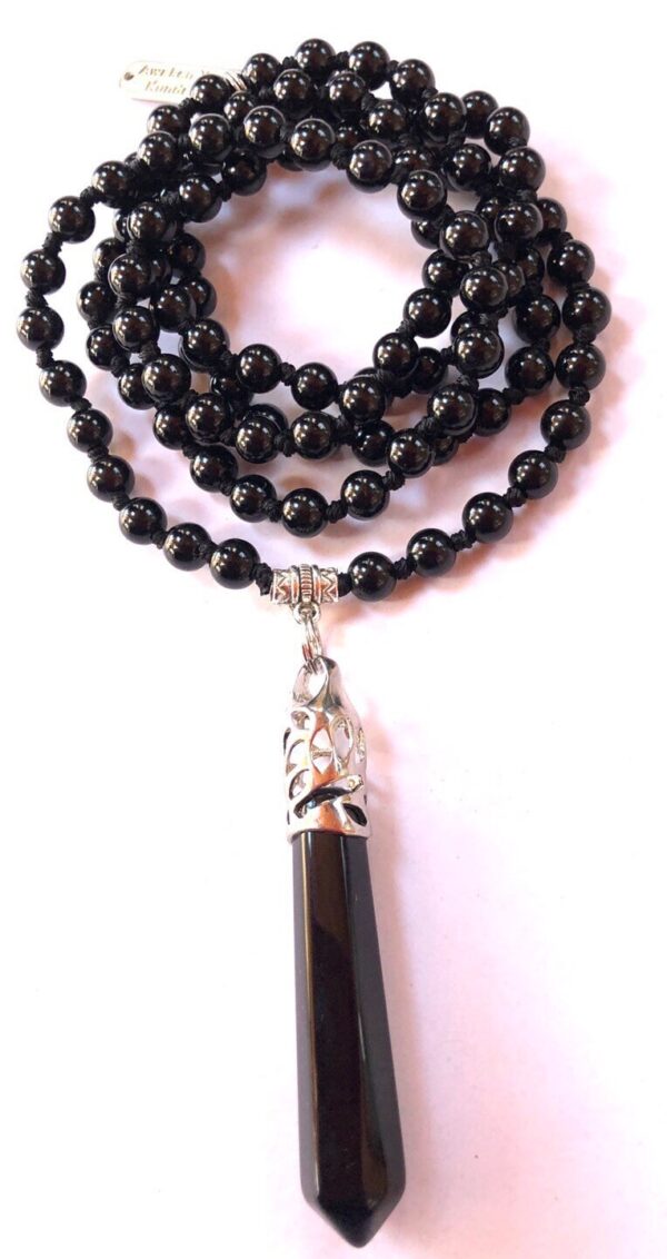 Black Jade Mala Necklace with 108 hand-knotted beads, designed for protection and stability, balancing the Root and Solar Plexus Chakras, resonating with the Taurus and Capricorn zodiac signs.