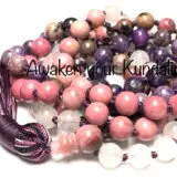 A Heart Chakra Mala Necklace featuring Rose Quartz, Rhodonite, Lepidolite, and Charoite beads, designed for emotional healing, self-love, and inner peace.