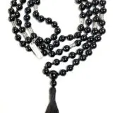 A Black Onyx Hand Knotted Mala Necklace designed to support the Root Chakra, offering protection, grounding, and strength, resonating with Sagittarius and Capricorn zodiac signs.