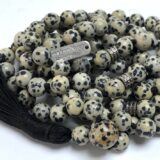 Dalmatian Jasper Mala Necklace featuring 108 hand-knotted Dalmatian Jasper beads, designed to promote joy and grounding. Ideal for meditation and spiritual practices, aligning with the Root and Sacral Chakras, and resonating with Gemini and Virgo. 