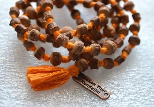 Tulsi Mala Beads Necklace featuring genuine Tulsi wood beads, designed for Root and Heart Chakra balance and spiritual purification.