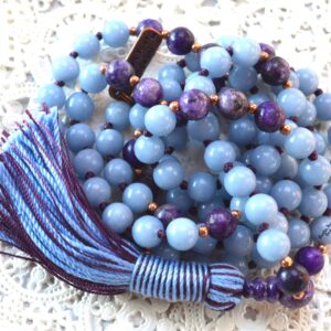 A Charoite & Angelite Mala Necklace with 108 hand-knotted beads designed to activate the Third Eye and Crown Chakras, promoting spiritual awareness and calm. Ideal for meditation, this necklace resonates with Pisces and Aquarius, offering spiritual growth and emotional tranquility.