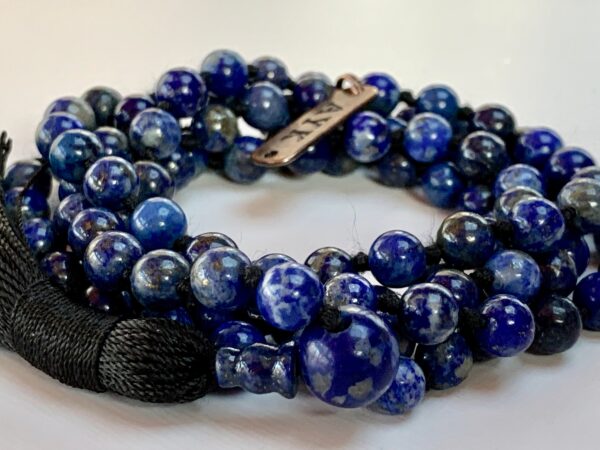 A Lapis Lazuli Necklace featuring 108 beads plus 1 guru bead. This necklace supports the Third Eye and Throat Chakras, resonates with Sagittarius and Libra, and promotes intuition and communication. Handcrafted for quality and comfort, it’s suitable for meditation and spiritual practice.