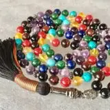 A 7 Chakra Mala Necklace featuring a combination of gemstones representing each of the seven chakras, designed for chakra alignment, balance, and spiritual growth.