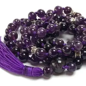 An Amethyst Mala Necklace featuring smooth, genuine amethyst beads in deep purple tones. The necklace is hand-knotted between each bead for durability and finished with a beautifully crafted tassel. It supports the Crown Chakra, enhancing intuition and promoting serenity.