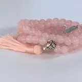 A Rose Quartz Mala Necklace with 108 beads plus 1 guru bead. Supports the Heart Chakra, promoting love and compassion. Smooth, pink gemstones resonate with Taurus and Libra for emotional balance. Handcrafted for comfort, ideal for meditation and spiritual practice