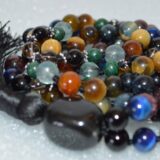 Blue Hawk's Eye and Gray Golden Tiger Eye Mala Necklace with Garnet, Malachite, Fluorite, Smoky Quartz, Onyx, Carnelian, Mahogany Obsidian, and Tourmaline Mala Necklace, designed for grounding, protection, and focus.