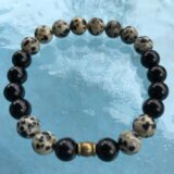  Genuine Black Tourmaline & Dalmatian Mala Bracelet designed for spiritual protection, grounding, and meditation, featuring natural gemstone beads associated with the Root Chakra and October birthstone.