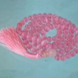 A Pink Cat's Eye Mala Necklace designed for Heart Chakra alignment, resonating with Taurus and Libra energies, enhancing love and emotional healing.