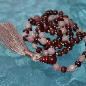 A Rhodonite and Rosewood Mala Necklace with 108 beads plus 1 guru bead. This necklace supports the Heart Chakra, resonates with Libra and Taurus, and promotes emotional healing and love. Handcrafted for quality and comfort, ideal for meditation and spiritual practice.