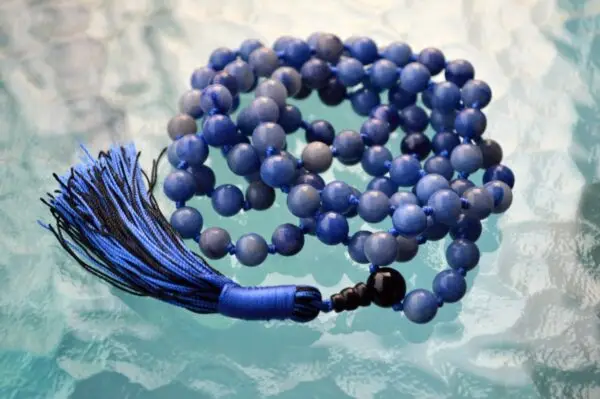 cA Blue Aventurine Mala Necklace with 108 beads, associated with the Throat Chakra, designed for Gemini zodiac signs, promoting communication and clarity.