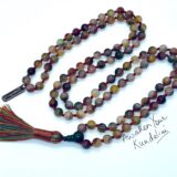 A Multicolored Agate Mala Beads Necklace featuring 108 hand-crafted agate beads, designed to balance the Root and Sacral Chakras, enhancing grounding and creativity, and resonating with Taurus and Gemini zodiac signs.