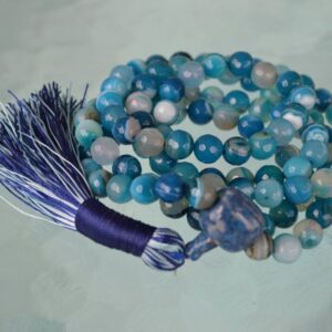 A Blue Crazy Agate Mala Necklace featuring 108 beads plus 1 guru bead. This necklace supports the Throat and Third Eye Chakras, resonates with Gemini and Pisces, and promotes clarity and communication. Handcrafted for quality and comfort, it’s suitable for meditation and spiritual practice.