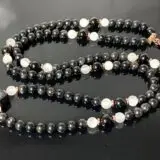  Astrophyllite, Selenite, and Black Tourmaline Mala Necklace featuring genuine beads, designed for Crown and Soul Chakra balance and spiritual growth for Capricorn.