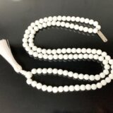 White Jade Mala Necklace featuring 108 hand-knotted White Jade beads, designed to enhance harmony and purity. Ideal for meditation and spiritual practices, aligning with the Crown and Heart Chakras, and resonating with Libra and Pisces.