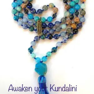 A Blue Throat Chakra Balancing Mala Necklace with Aquamarine, Lapis Lazuli, Labradorite, Amazonite, Chrysocolla, Ocean Jasper, Blue Tiger Eye, Sodalite, Turquoise, and Aventurine. Includes 108 beads plus 1 guru bead. Handcrafted in the USA for meditation and clarity.