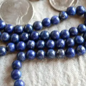 Lapis Lazuli Mala Beads Necklace featuring 108 Lapis Lazuli beads and 1 guru bead. The necklace supports Throat Chakra healing, enhancing wisdom, communication, and self-expression. Handcrafted in the USA, ideal for meditation and as a spiritual accessory.