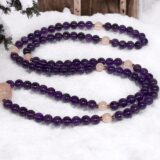 A versatile Amethyst & Rose Quartz Wrap Mala Necklace with 108 beads plus 1 guru bead, supporting the Crown and Heart Chakras, resonating with Pisces. Promotes love, emotional healing, and spiritual awareness. Hand-knotted for meditation and flexibility.