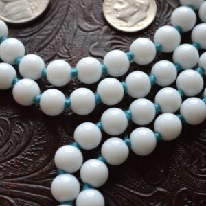 White Jade Mala Necklace featuring 108 white jade beads knotted with turquoise thread and tassel for clarity and spiritual peace, supporting the Crown Chakra, ideal for Pisces and Libra zodiac signs.