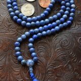 A Sodalite Mala Beads Necklace designed for communication and intuition, featuring 108 hand-knotted beads in deep blue, resonating with the Throat and Third Eye Chakras, ideal for Sagittarius.