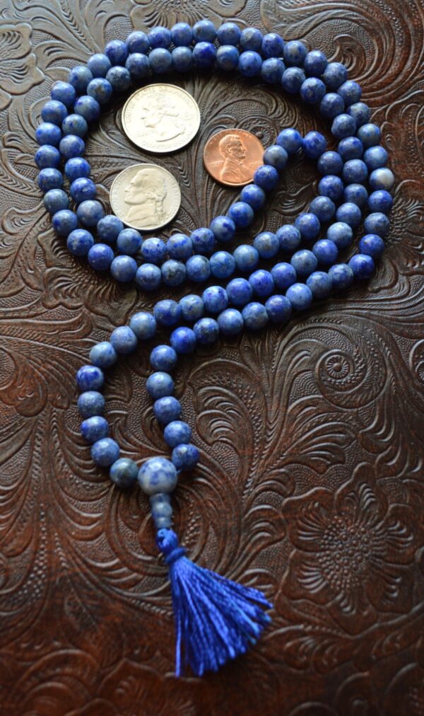 A Sodalite Mala Beads Necklace designed for communication and intuition, featuring 108 hand-knotted beads in deep blue, resonating with the Throat and Third Eye Chakras, ideal for Sagittarius.