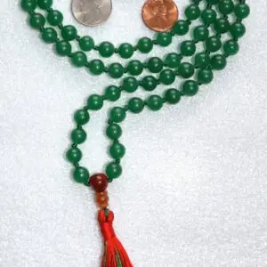 A Green Mashan Jade Mala Necklace featuring 108 beads plus 1 guru bead. This necklace supports the Heart Chakra and resonates with Aries and Libra, promoting harmony, prosperity, and emotional balance. Handcrafted, it’s perfect for meditation and spiritual practice.