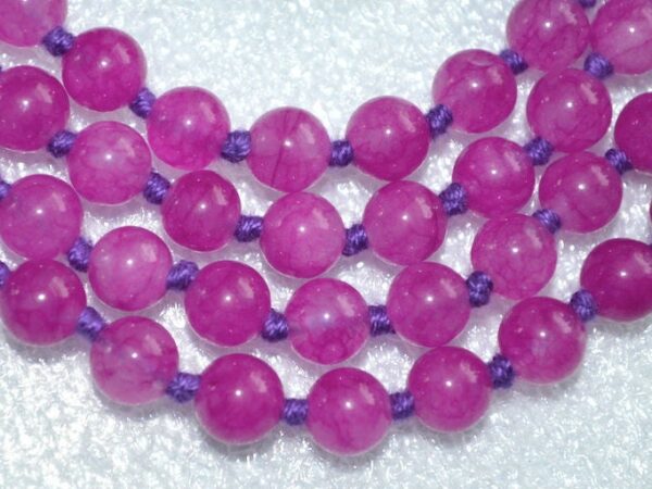 Magenta Agate Knotted Mala Necklace featuring 108 hand-knotted beads, activating the Root and Heart Chakras for strength and balance, associated with Aries and Scorpio.