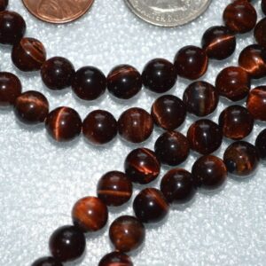 Red Tiger Eye Mala Necklace featuring 108 hand-knotted beads for grounding, vitality, and confidence, aligned with Capricorn and Scorpio zodiac signs.